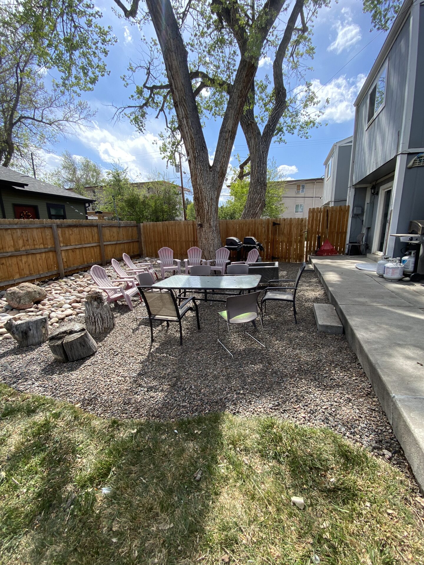 Outdoor seating area with gravel, stone bed and fence